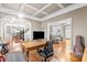Open-concept office with desk, wood floors, views to the dining room, staircase and living room at 3821 Falls River Ave, Raleigh, NC 27614