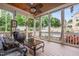 Relaxing screened-in patio with ceiling fan, wicker furniture, overlooking the pool at 3821 Falls River Ave, Raleigh, NC 27614