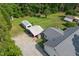 Aerial view of home with multiple outbuildings, large yard, and car under metal carport at 4022 Avents Ferry Rd, Sanford, NC 27330