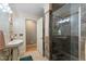 Traditional bathroom features a tiled shower with glass door, pedestal sink, and neutral wall color at 4022 Avents Ferry Rd, Sanford, NC 27330