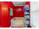 Bathroom featuring a soaking tub with a towel rack and red paneled walls at 4022 Avents Ferry Rd, Sanford, NC 27330
