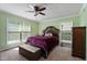 Comfortable bedroom with a plush bed, ceiling fan, and large windows at 4022 Avents Ferry Rd, Sanford, NC 27330