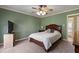 Comfortable bedroom featuring a ceiling fan, neutral carpeting, and ample natural light at 4022 Avents Ferry Rd, Sanford, NC 27330