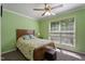 Bedroom with a large window, floral bedding, and a small ottoman at 4022 Avents Ferry Rd, Sanford, NC 27330