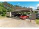 Carport featuring parking for a red car and covered boat with an outbuilding adjacent at 4022 Avents Ferry Rd, Sanford, NC 27330