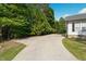 Long driveway with large parking area and green foliage on the side of the house at 4022 Avents Ferry Rd, Sanford, NC 27330
