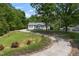 Exterior view of a house with a long driveway and landscaped front yard at 4022 Avents Ferry Rd, Sanford, NC 27330