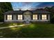 Night view of single-story home with pathway lighting and a well-manicured lawn at 4022 Avents Ferry Rd, Sanford, NC 27330