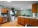 Eat in kitchen with a stainless steel fridge, light countertops, and wood floors at 4022 Avents Ferry Rd, Sanford, NC 27330