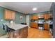 Eat in kitchen featuring stainless steel appliances, granite countertops, and wood cabinets at 4022 Avents Ferry Rd, Sanford, NC 27330