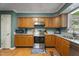 Well-lit kitchen with stainless steel appliances, wood cabinets, and granite countertops at 4022 Avents Ferry Rd, Sanford, NC 27330