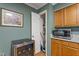 Eat in kitchen featuring a wine cooler, microwave, and overhead cabinet lighting at 4022 Avents Ferry Rd, Sanford, NC 27330