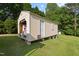 Exterior view of the outbuilding with white siding, concrete perimeter, and green lawn surrounding at 4022 Avents Ferry Rd, Sanford, NC 27330