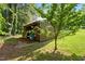 A backyard outbuilding with corrugated siding and blue barrel on concrete base at 4022 Avents Ferry Rd, Sanford, NC 27330