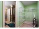 Spacious walk-in closet with shelving and adjacent door to a glass shower at 4022 Avents Ferry Rd, Sanford, NC 27330