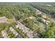 Aerial view of property surrounded by lush trees, near a baseball field and residential area at 414 Madison Ave, Cary, NC 27513