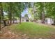 Expansive backyard with lush lawn, storage sheds and mature trees providing a peaceful outdoor space at 414 Madison Ave, Cary, NC 27513