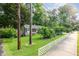 Charming home with well-maintained lawn and landscaping, enhanced by mature trees and a white picket fence at 414 Madison Ave, Cary, NC 27513