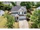 A birds eye view of a two-story home with stone accents, a well-maintained lawn, and two-car garage at 430 Dogwood Creek Pl, Fuquay Varina, NC 27526