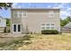 Backyard with grass, vinyl siding, patio, and a back door at 430 Dogwood Creek Pl, Fuquay Varina, NC 27526
