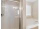 Bright bathroom with walk-in shower and soaking tub below a window at 430 Dogwood Creek Pl, Fuquay Varina, NC 27526