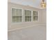 Light-filled bedroom with plush carpet, neutral walls, and three large windows at 430 Dogwood Creek Pl, Fuquay Varina, NC 27526