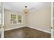 Bedroom featuring laminate floors, a modern light fixture, and sunlit windows at 430 Dogwood Creek Pl, Fuquay Varina, NC 27526