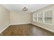 Bedroom featuring laminate floors, modern light fixture, and bright windows at 430 Dogwood Creek Pl, Fuquay Varina, NC 27526