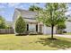 A side view showing a two-story home with manicured shrubs, lawn, and a two-car garage at 430 Dogwood Creek Pl, Fuquay Varina, NC 27526