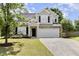 Charming two-story home with stone accents, a well-maintained lawn, and a spacious two-car garage at 430 Dogwood Creek Pl, Fuquay Varina, NC 27526