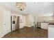 Modern kitchen featuring stainless steel appliances, white cabinets, and stylish lighting at 430 Dogwood Creek Pl, Fuquay Varina, NC 27526