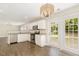 Well-equipped kitchen with stainless appliances, white cabinetry, granite counters, and french doors at 430 Dogwood Creek Pl, Fuquay Varina, NC 27526