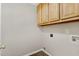 Laundry area with wooden cabinets and washer and dryer hookups at 430 Dogwood Creek Pl, Fuquay Varina, NC 27526