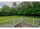 Enjoy scenic views from the back deck overlooking the lush green lawn and trees at 4667 Freedom Dr, Burlington, NC 27215