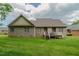 Lovely single-story brick home featuring a cozy back deck and well-manicured lawn at 4667 Freedom Dr, Burlington, NC 27215