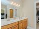Bathroom with a double sink vanity and a walk-in closet providing ample storage space at 4667 Freedom Dr, Burlington, NC 27215