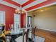 Formal dining room with striking red walls, chandelier, and open view to living spaces at 4667 Freedom Dr, Burlington, NC 27215