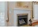 Close up of living room fireplace with white mantel, tile surround, and charming decor at 4667 Freedom Dr, Burlington, NC 27215