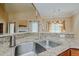 Stainless steel sink with granite countertops and view to the adjacent living area at 4667 Freedom Dr, Burlington, NC 27215