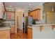 A kitchen with wooden cabinets, stainless steel appliances, granite counters with open view to an adjacent room at 4667 Freedom Dr, Burlington, NC 27215