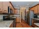 A kitchen showcases wooden cabinets, granite countertops, and stainless steel appliances at 4667 Freedom Dr, Burlington, NC 27215
