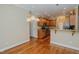 A kitchen connects to the open dining area with hardwood floors and decorative lighting at 4667 Freedom Dr, Burlington, NC 27215