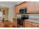 A kitchen showcases wooden cabinets, granite countertops, and stainless steel appliances at 4667 Freedom Dr, Burlington, NC 27215