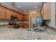 Granite countertops accent wooden cabinetry and stainless steel appliances in this kitchen at 4667 Freedom Dr, Burlington, NC 27215
