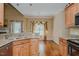 The open kitchen features granite countertops, wooden cabinets, and stainless steel sink with open dining area at 4667 Freedom Dr, Burlington, NC 27215