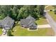 Aerial view of the home showing its brick and siding exterior, driveway, and mature trees at 48 Arlington Dr, Cameron, NC 28326