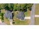 An aerial view showcasing two residences with well-maintained yards in a tree-lined neighborhood at 48 Arlington Dr, Cameron, NC 28326
