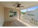 Covered back porch with ceiling fan, wooden deck, and view of backyard and adjacent homes at 48 Arlington Dr, Cameron, NC 28326