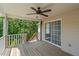 Covered back porch features a ceiling fan, access to the backyard, and a sliding glass door at 48 Arlington Dr, Cameron, NC 28326