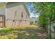 Fenced backyard with lawn, brick foundation, and vinyl siding at 48 Arlington Dr, Cameron, NC 28326